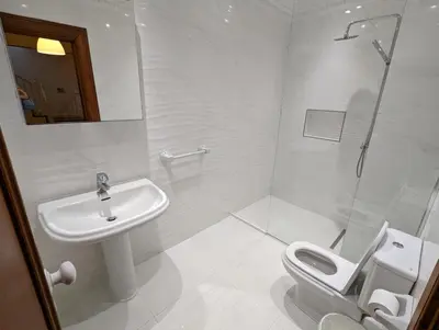a white bathroom with a sink and a toilet at Casa Roc Madeira - 5 Bedrooms - Ocean and City Views - Private Heated Pool in Funchal