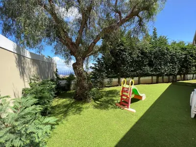 a yard with a tree and a playground at Casa Roc Madeira - 5 Bedrooms - Ocean and City Views - Private Heated Pool in Funchal