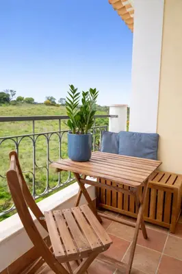 a swimming pool in a villa with palm trees at Santa Maria Apartment at Porto de Mos beach in Lagos