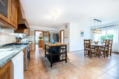 a kitchen with a table and a dining room at Casa dos Sonhadores in Aljezur