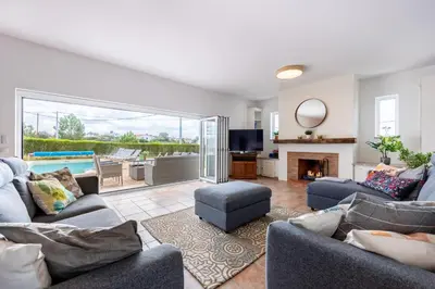 a living room with two couches and a fireplace at Casa dos Sonhadores in Aljezur
