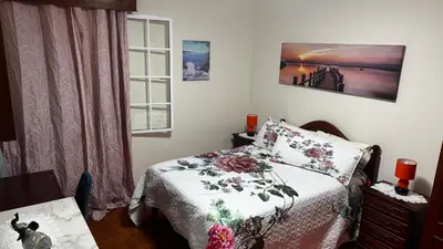 a small bedroom with a bed and a window at Terra Chã Cottage,FEEL Home, in São Vicente