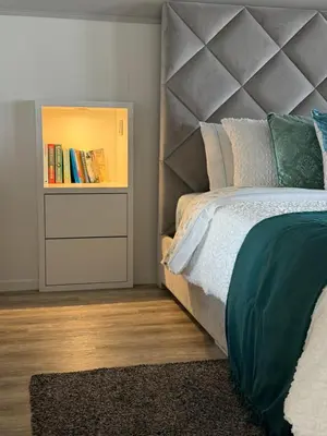 a bedroom with a bed and a book shelf at Studio privado com vista mar e montanha in Ponta do Sol