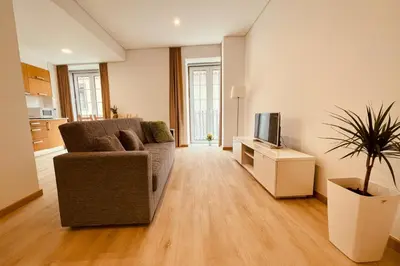 a living room with a couch and a tv at Living Funchal X in Funchal