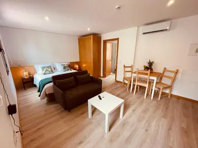 a room with a bed and a couch and a table at Living Funchal X in Funchal