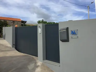 a gray fence with a gate with an ak sign on it at Calheta Ocean View Apartments 1 - Air Condition in Estreito da Calheta