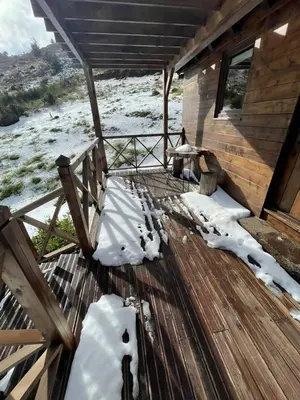a wooden deck with snow on the floor of a cabin at Mountain Eco Shelter 1 in Funchal