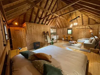 a bedroom with a large bed in a wooden room at Mountain Eco Shelter 2 in Funchal