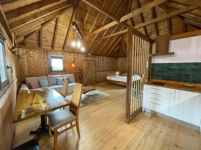 a large room with a dining table and a bedroom at Mountain Eco Shelter 2 in Funchal