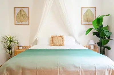 a white bedroom with a bed with a green bedspread at Unique Tropical Style Penthouse with a Dreamy View - by Portugal Collection in Calheta