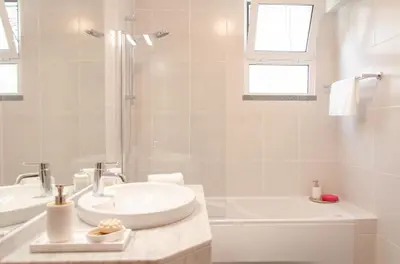 a white bathroom with a sink and a tub at Unique Tropical Style Penthouse with a Dreamy View - by Portugal Collection in Calheta