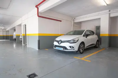 a small white car parked in a parking garage at Unique Tropical Style Penthouse with a Dreamy View - by Portugal Collection in Calheta