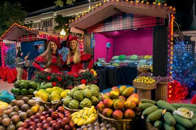 two women standing in front of a market with fruits and vegetables at Unique Tropical Style Penthouse with a Dreamy View - by Portugal Collection in Calheta