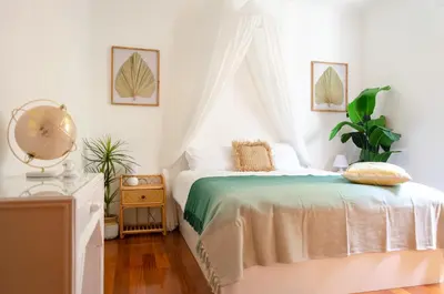 a white bedroom with a bed with a canopy at Unique Tropical Style Penthouse with a Dreamy View - by Portugal Collection in Calheta