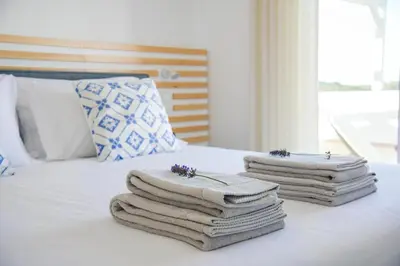 a pile of towels sitting on top of a bed at Casa da costa in Carrapateira