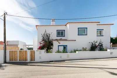 a white house with a white fence at Casa da costa in Carrapateira