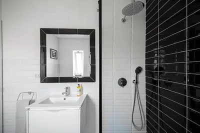 a white bathroom with a sink and a mirror at Casa da costa in Carrapateira