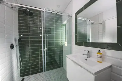 a bathroom with a sink and a glass shower at Casa da costa in Carrapateira