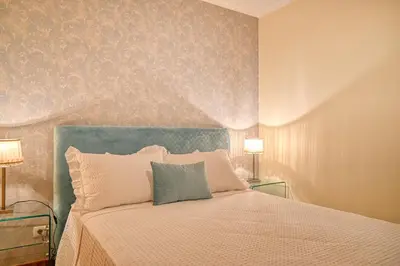 a bedroom with a large bed with two lamps at Villa Mendonça, a Home in Madeira in Canhas