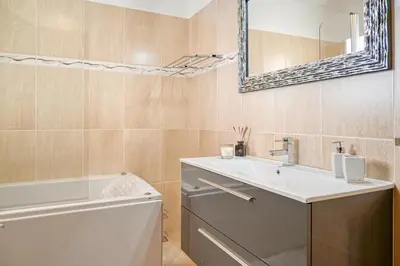 a bathroom with a sink and a tub and a mirror at Villa Mendonça, a Home in Madeira in Canhas