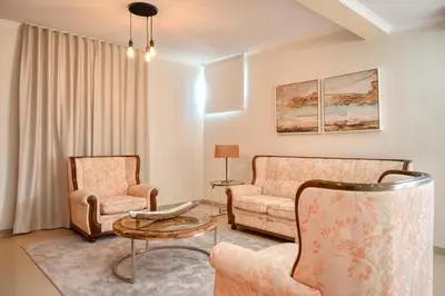 a living room with two chairs and a table at Villa Mendonça, a Home in Madeira in Canhas