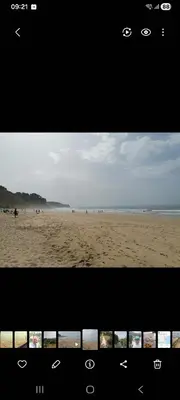 a picture of a beach with people on the sand at Spacious Apartment near Porto de Mos Beach, Lagos. in Lagos