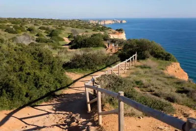 a trail on the side of a cliff near the ocean at Spacious Apartment near Porto de Mos Beach, Lagos. in Lagos