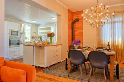 a kitchen and dining room with a table and chairs at Villa Santa Madalena, a Home in Madeira in Arco da Calheta