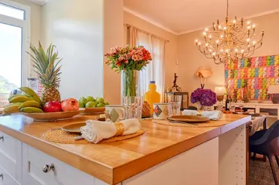 a kitchen with a table with fruit on it at Villa Santa Madalena, a Home in Madeira in Arco da Calheta