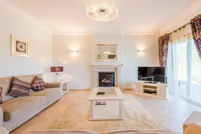 a living room with a couch and a fireplace at Boavista Golf and Spa Resort - 101 in Lagos