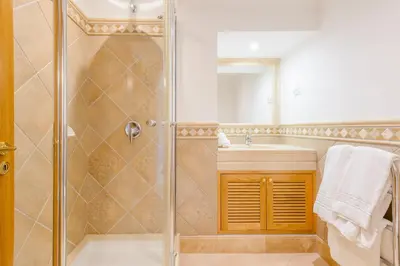 a bathroom with a shower and a sink at Boavista Golf and Spa Resort - 101 in Lagos