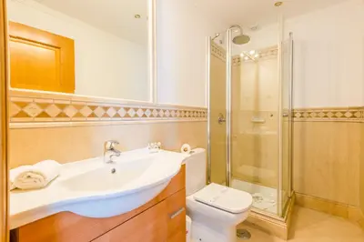 a bathroom with a toilet and a sink and a shower at Boavista Golf and Spa Resort - 101 in Lagos