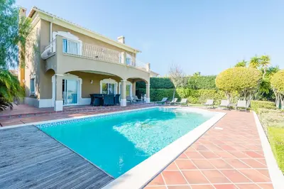 a swimming pool in front of a house at Boavista Golf and Spa Resort - 101 in Lagos