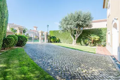 a cobblestone driveway in front of a house at Boavista Golf and Spa Resort - 101 in Lagos