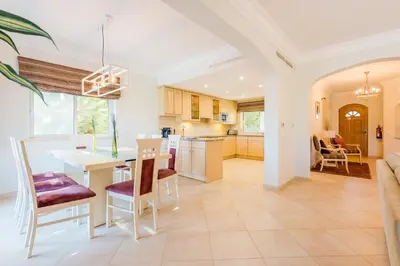a kitchen and living room with a table and chairs at Boavista Golf and Spa Resort - 101 in Lagos