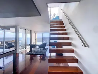 a kitchen with a large island with black counter tops at Luxurious Penthouse Suites direct on sea in Caniço