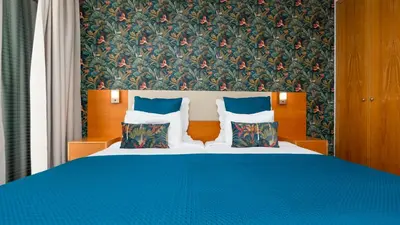 a bedroom with a blue bed with pillows at The Seaview Studio by LovelyStay in Caniço