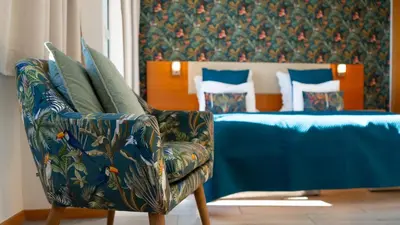 a bedroom with a couch and a chair and a bed at The Seaview Studio by LovelyStay in Caniço