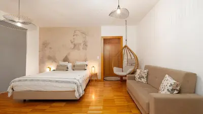 a living room with a bed and a couch and a tv at The Loft by LovelyStay in Funchal