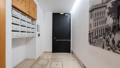 a bedroom with a large bed and a mirror at The Loft by LovelyStay in Funchal
