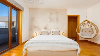 a bedroom with a large bed and a balcony at The Loft by LovelyStay in Funchal