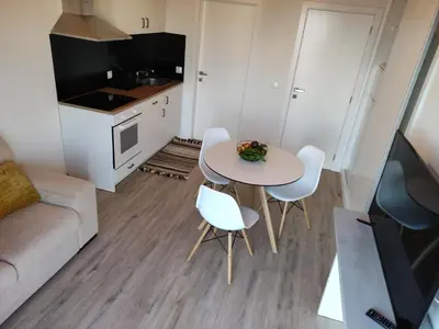 a small living room with a white table and chairs at Ponta do Sol Private Apartment Sea View in Ponta do Sol