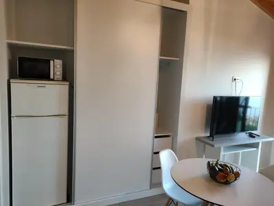 a small kitchen with a table and a microwave at Ponta do Sol Private Apartment Sea View in Ponta do Sol