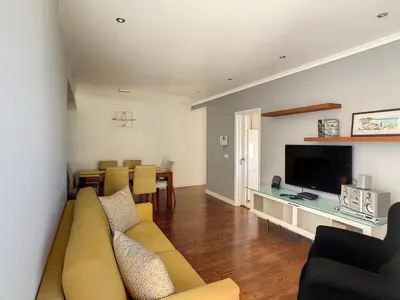 a living room with a couch and a flat screen tv at Lido Life Apartment by LovelyStay in Funchal