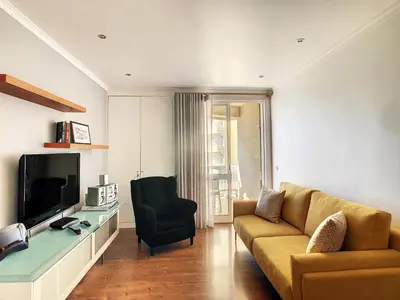 a living room with a couch and a television at Lido Life Apartment by LovelyStay in Funchal