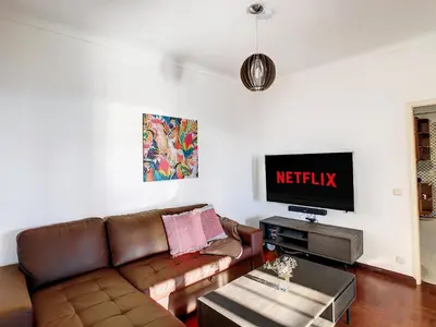 a living room with a couch and a television at Casa Bergmann by LovelyStay in Funchal