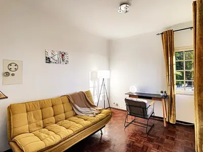 a living room with a couch and a desk at Casa Bergmann by LovelyStay in Funchal