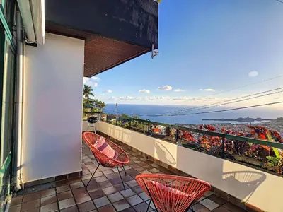 a balcony with chairs and a view of the ocean at Casa Bergmann by LovelyStay in Funchal
