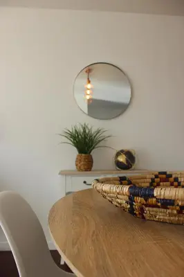 a dining room table with a mirror on the wall at D Apartment - your home with breathtaking Views in Funchal