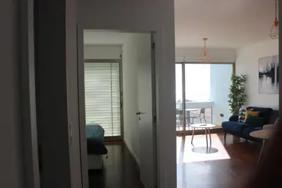 a living room with a blue couch and a table at D Apartment - your home with breathtaking Views in Funchal
